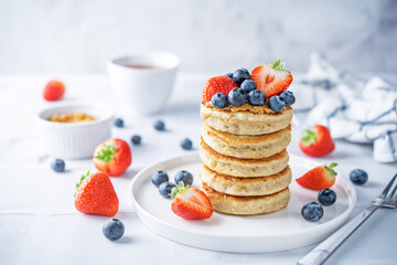 Banana pancakes with strawberries and blueberries