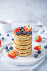 Banana pancakes with strawberries and blueberries