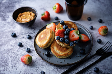 Banana pancakes with strawberries and blueberries