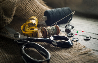 Needle and thread, scissors, sewing machine. Tailor's, fashion designer's, and seamstress's tools....