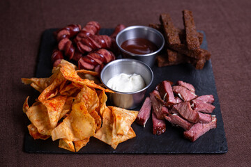 set snack to beer from sausages, crackers, chips and smoked meat
