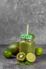 Diet and detox concept. Green smoothie with spinach