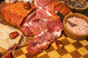 Meat, Pork neck in marinade and on a chopping boardon. Raw steak meat pork neck on chopping board with chili. Raw meat for grilling. Black background.
