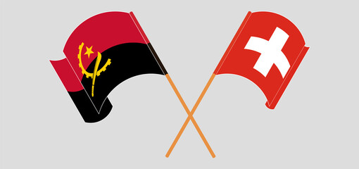 Crossed and waving flags of Angola and Switzerland