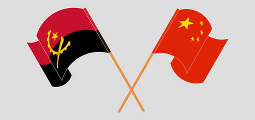 Crossed and waving flags of Angola and China