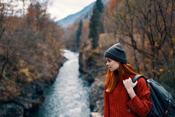woman hiker on the bridge near the river mountains travel nature