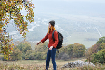 woman hiker travel in the mountains autumn trees vacation