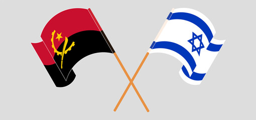 Crossed and waving flags of Angola and Israel