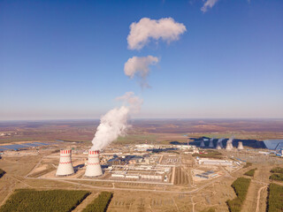 Nuclear power plant emissions of steam in the air atmosphere. Industrial zone with emission of...