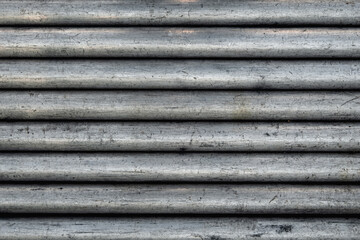 Old grunge striped background. Steel tubes