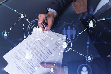 A potential employee in formal suit signing the contract to boost his career and gain new...