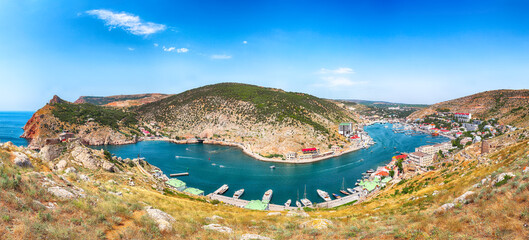 Panoramic view of Balaklava bay with yachts and ruines of Genoese fortress Chembalo in Sevastopol city from the height