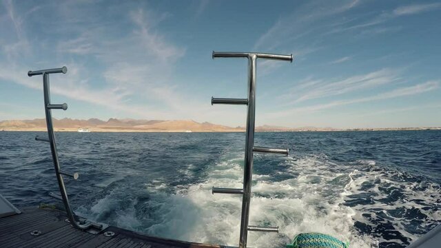 Sea trip travel journey tour on a tourist yacht in the Red Sea. Seething waves astern 