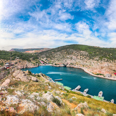 Fototapeta na wymiar Scenic view of Balaklava bay with yachts and ruines of Genoese fortress Chembalo in Sevastopol city from the height
