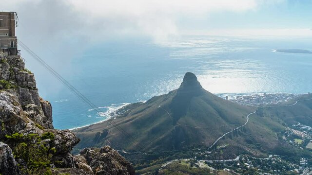 Zoom out timelapse view of natural landmark Lions Head and Table Mountain cableway in Cape Town, South Africa. 