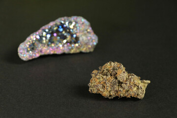 cannabis bud and gemstone dark background