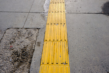 Yellow street covers in order to orient blind people during walking.
