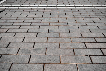 Modern tile and cobblestone way, paving stone and white street lines near city park for pedestrians way made of concrete stone ground floor outside