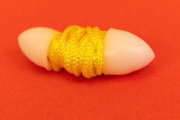 Silicone ear plugs for human ears on red background