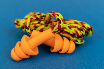 Silicone ear plugs for human ears on blue background