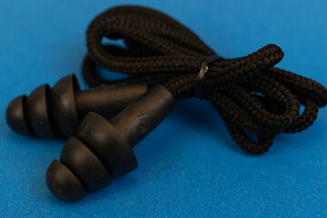 Silicone ear plugs for human ears on blue background