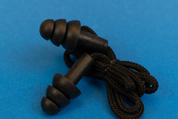 Silicone ear plugs for human ears on blue background