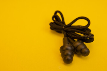 Silicone ear plugs for human ears on yellow background