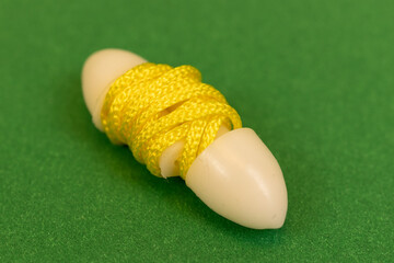 Silicone reusable ear plugs for human ears on green background