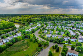 Fototapeta na wymiar Aerial view roofs of the near a river town houses East Brunswick in the urban landscape of a small sleeping area New Jersey