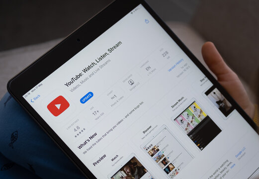 YouTube App Seen On The Screen Of Ipad Which Is In The Hands Of Bored Unrecognisable Child. Concept. Stafford, United Kingdom, May 18, 2021.