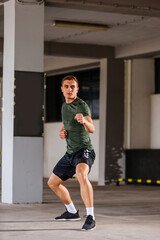 Obraz premium Fit sports man doing jump kick outdoors