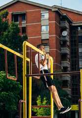 Man pulled on a horizontal bar, exercise outdoors