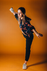 Contemporary style dancer on orange wall