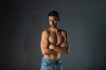 Portrait of an attractive stylish man posing against dark background