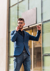 Young businessman in blue suit walking through downtown