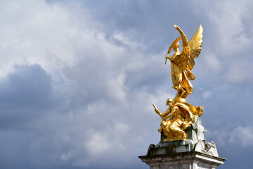 Detail of Victoria Memorial against dramatic sky, London, UK