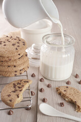breakfast of freshly baked chocolate chip cookies on a metal rack with fresh milk for hunting