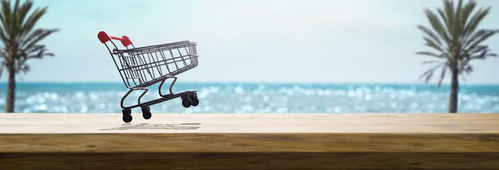 shopping cart on a table on a sunny summer day with the beach in the background