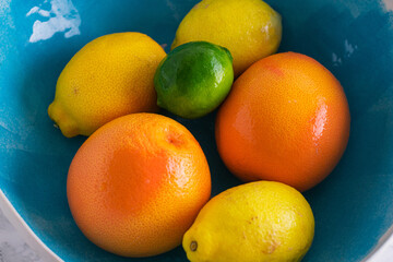 Oranges, lemons, lime colourful fruit on marble background