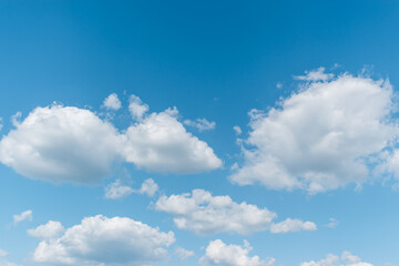 Naklejka na ściany i meble White clouds in the blue sky background.