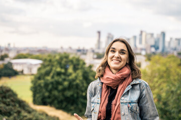 Portrait of a beautiful young woman outdoors in the city. Urban landscape. Travel and freelance lifestyle. Youth and beauty