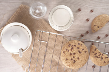 breakfast of freshly baked chocolate chip cookies on a metal rack with fresh milk for hunting