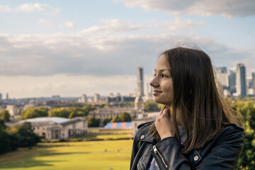 Portrait of a beautiful young woman outdoors in the city. Urban landscape. Travel and freelance lifestyle. Youth and beauty