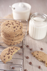 breakfast of freshly baked chocolate chip cookies on a metal rack with fresh milk for hunting