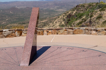 large sundial at scenic lookout point with mountains in the background