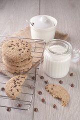 breakfast of freshly baked chocolate chip cookies on a metal rack with fresh milk for hunting