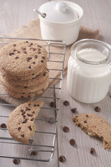 breakfast of freshly baked chocolate chip cookies on a metal rack with fresh milk for hunting