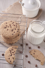 breakfast of freshly baked chocolate chip cookies on a metal rack with fresh milk for hunting