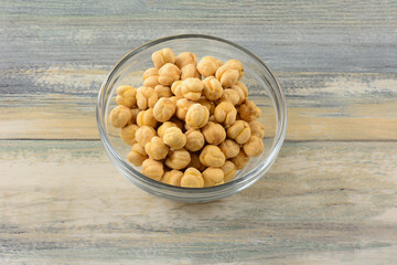 Turkish salted roasted chickpeas in glass snack bowl on table
