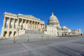 Wide angle view of United States Capitol  Building under blue sky, Washington DC